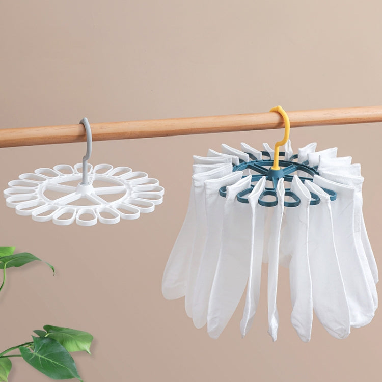 Round laundry sock drying hanger with 20 white clips on a bar
