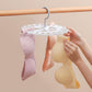 Round sock hanger with 20 white clips holding pink, cream, and tan socks