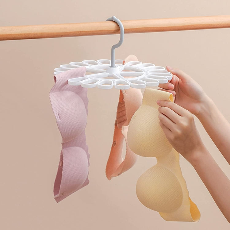 Round sock hanger with 20 white clips holding pink, cream, and tan socks