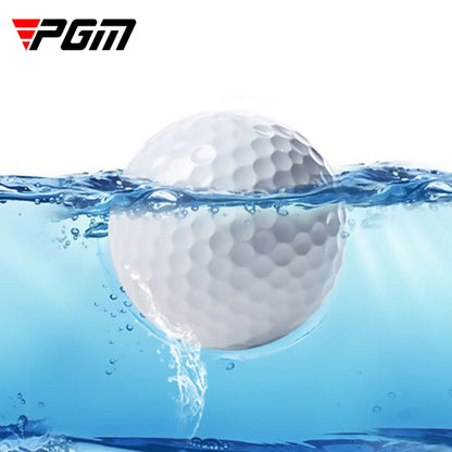 Floating golf practice ball in water, white dimpled surface