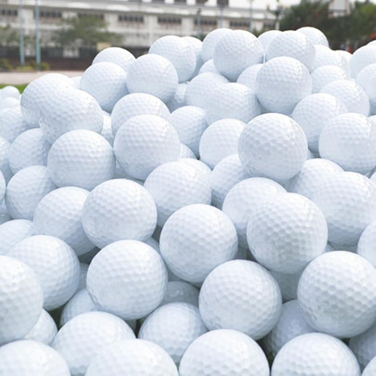 Pile of white floating golf practice balls, dimpled surface