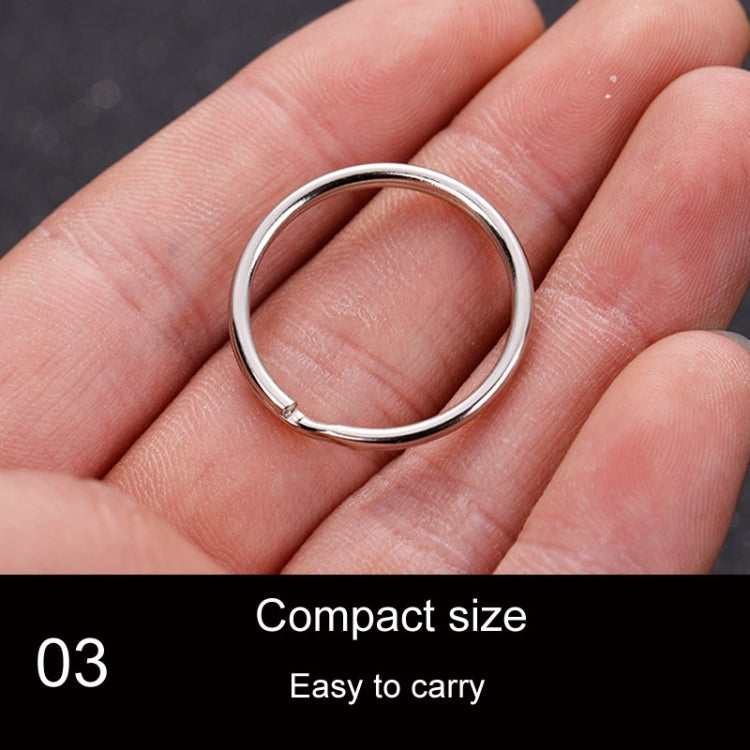 Small polished metal key holder ring held in hand