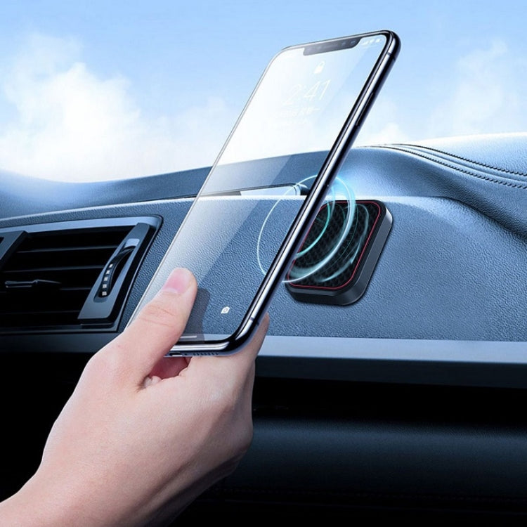 Car dashboard magnetic holder holding a smartphone near an air vent