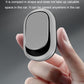 Silver oval adhesive car hook with black insert, held by hand to open