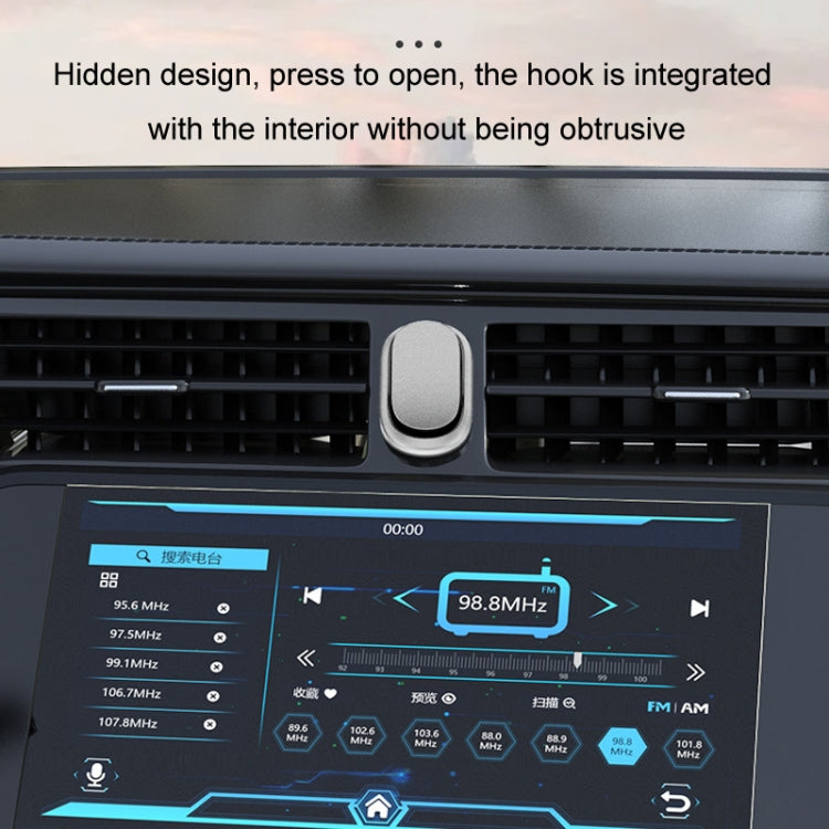 Silver oval adhesive car hook installed on dashboard vent, press-to-open style