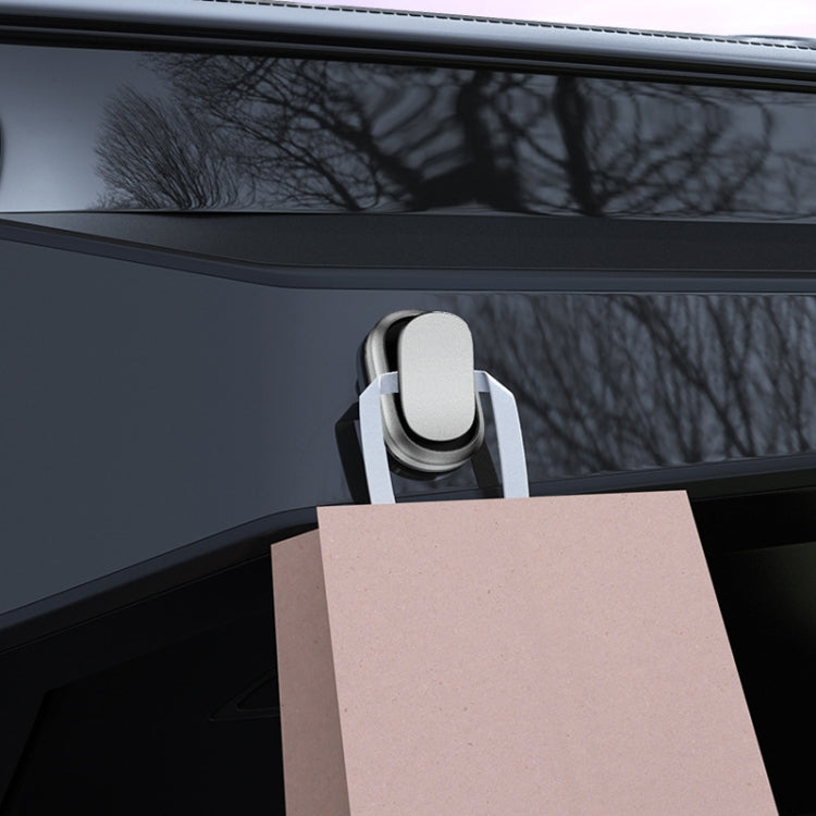 Silver oval adhesive car hook with black base holding a card