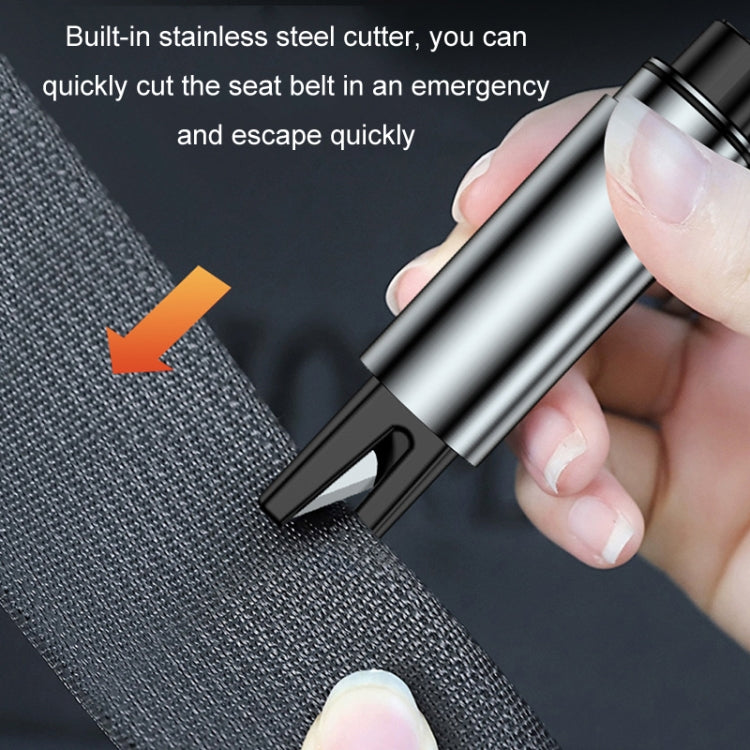 Car emergency escape hammer with built-in belt cutter cutting car seat fabric.