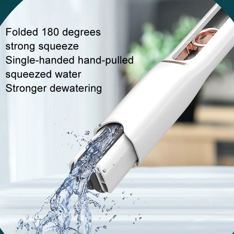 White mini mop with gray head angled forward, water stream coming from nozzle