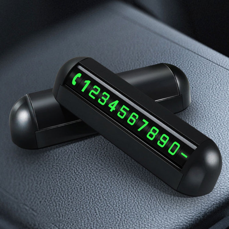 Black parking number display with glowing green digits on a dashboard surface