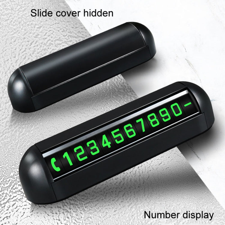 Black parking number display with slide cover closed and green digits visible