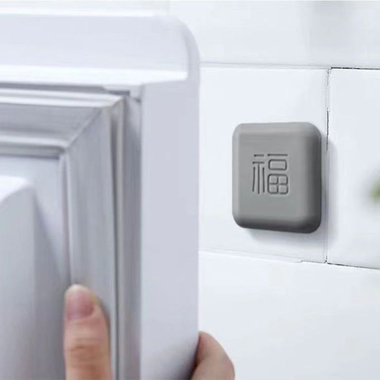 Gray square silicone door bumper pad with embossed logo, mounted on door edge
