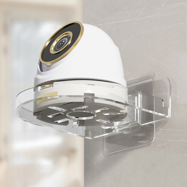 Transparent wall-mounted camera bracket holding a white security camera on a clear base
