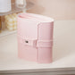Pink book-shaped jewelry bag with wrap strap and snap buckle, compact travel storage