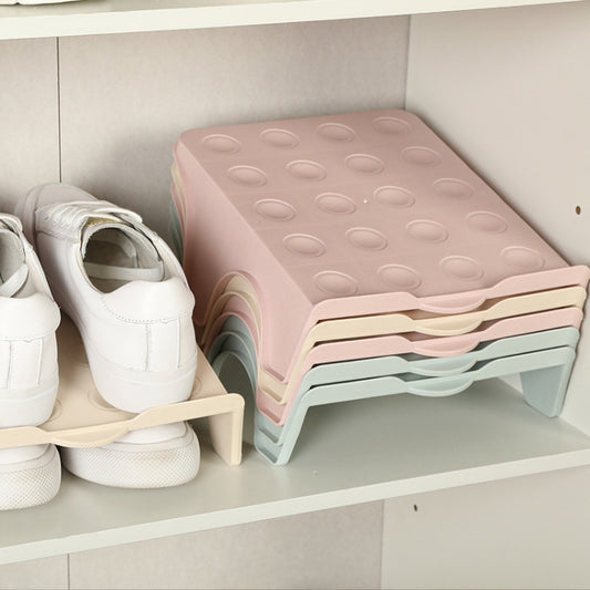 Pink stackable double shoe organizer with textured top tray and curved side cutouts