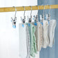 Laundry drying clips holding folded socks on a wooden bar, blue anti-scratch tabs