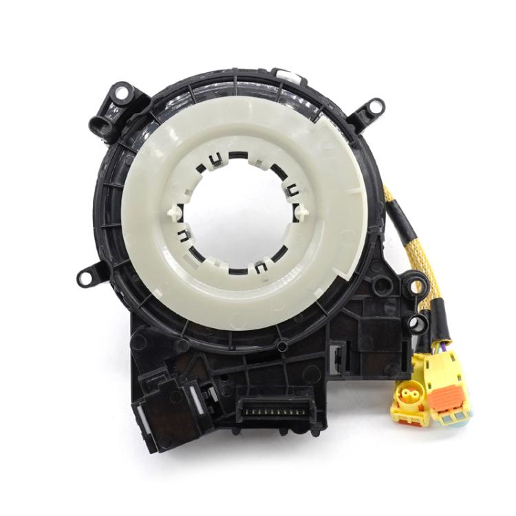 Clock spring coil with cream inner ring, black housing, and yellow wire leads