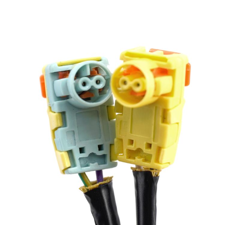 Clock spring connector pair with yellow housing and colored wiring terminals
