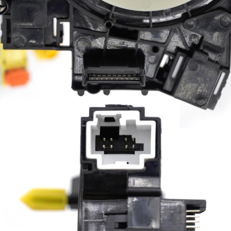 Clock spring ribbon connector detail with black plastic housing and contacts