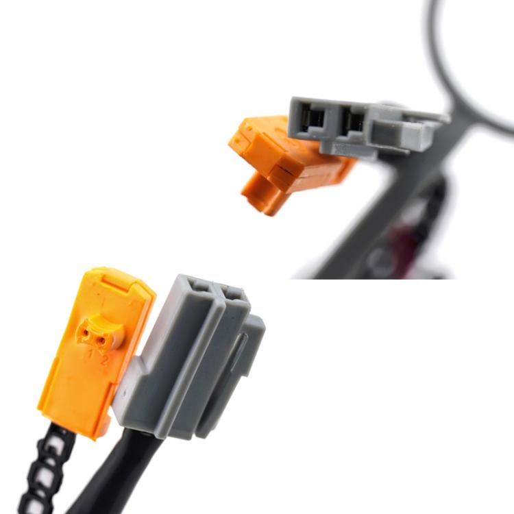 Close-up of steering wheel clock spring connector plugs, yellow and gray