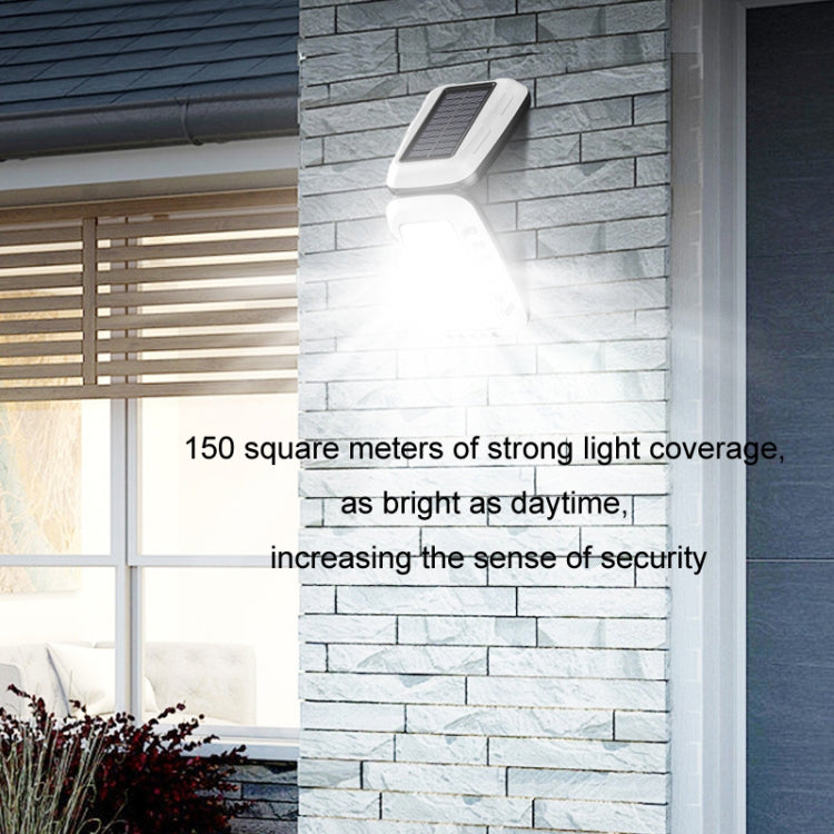Wall-mounted solar street light with bright LED illumination on a light gray brick wall