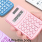 Pink ultra-thin calculator in hand with LCD display and button keypad