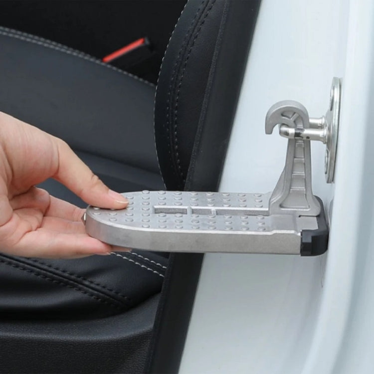Hand lifting gray foldable car foot pedal with safety hammer on the door