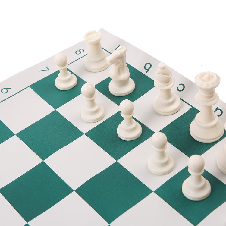 Foldable portable chess set close-up of white chess pieces on green-and-white board
