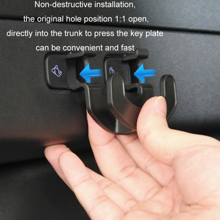 Trunk seat button hook snapped onto trunk keypad, shown with a hand pressing it.