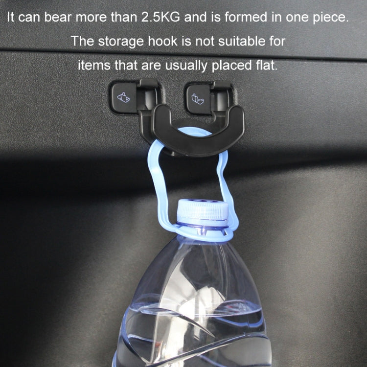 Black trunk seat button hook holding a bottle by the neck.