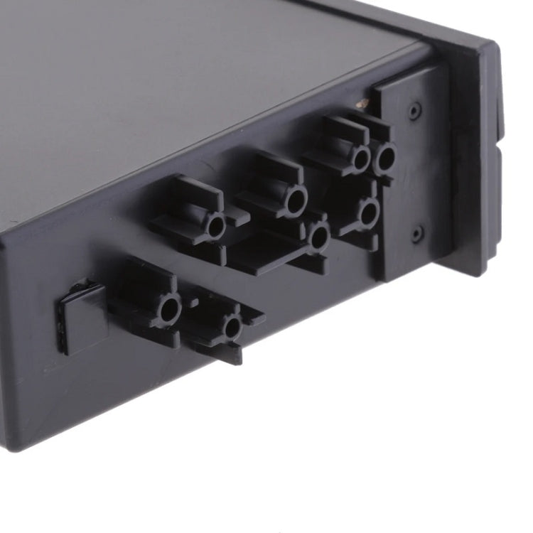 Car storage box interior showing mounting tabs and cup holder cutouts, dark gray
