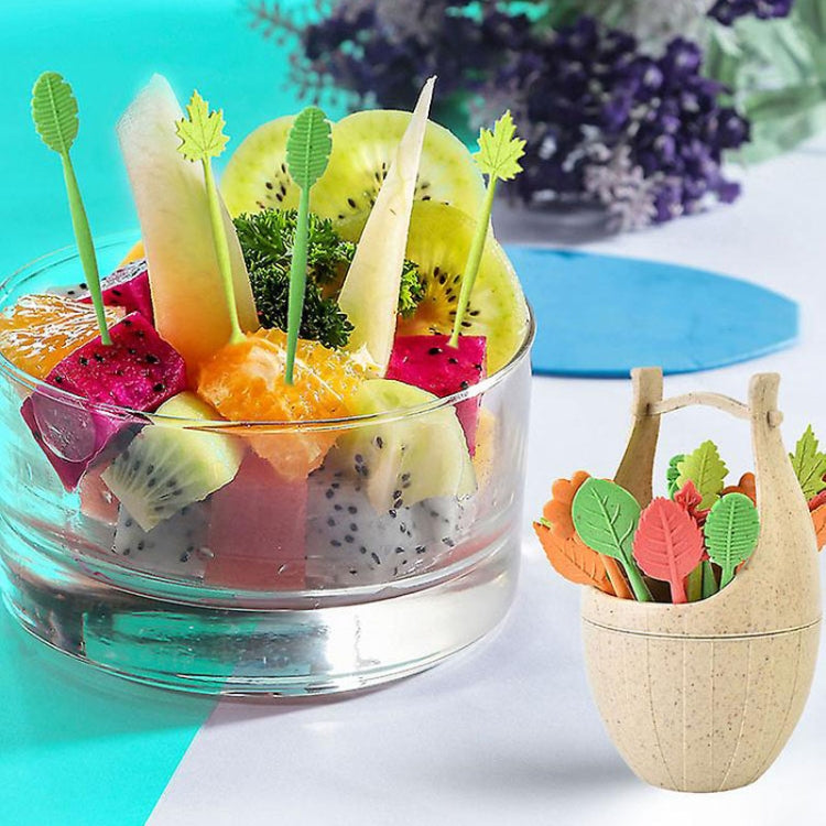 Wheat-fiber fruit fork picks with multicolor leaf tops beside a small cup holder