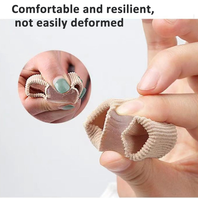 Beige double-hole toe separator orthosis held by hands, flexible knit
