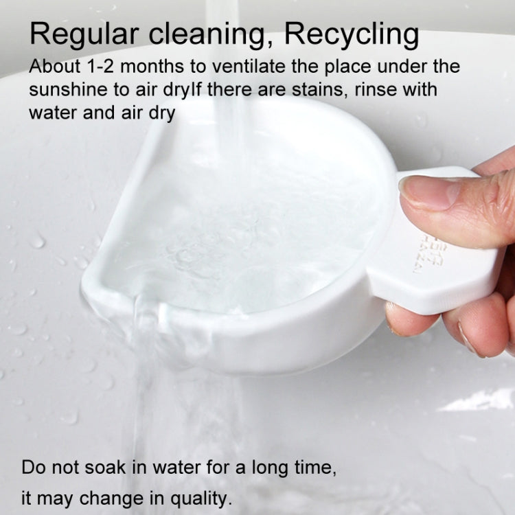 Hand holding a white drying scoop over a wet surface