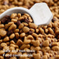 Close-up of white scoop resting on brown diatomaceous earth granules