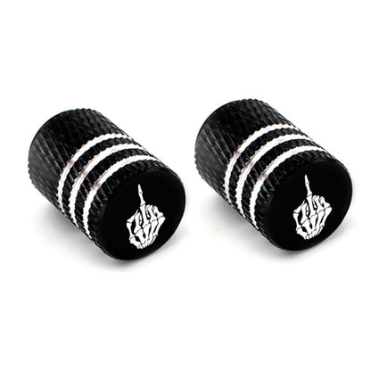 Pair of black tire valve stem caps with silver stripes and white skull emblems