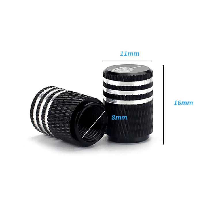 Black carbon-fiber style tire valve cap with silver-striped rings and white skull