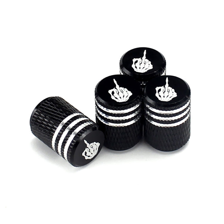 Set of black tire valve caps with silver stripes and white flame-skull emblem tops