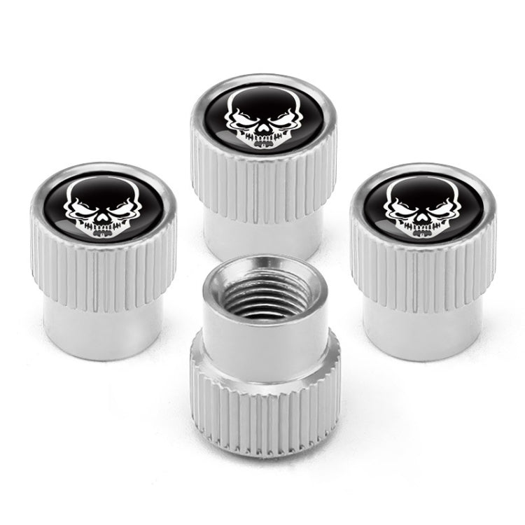 Set of 4 silver valve caps with black skull emblem and one visible threaded base