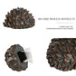 Pinecone-shaped key hiding safe with gray base and textured brown-and-orange tips