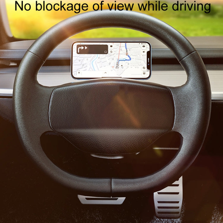 Black car phone navigation holder mounted on steering wheel spokes