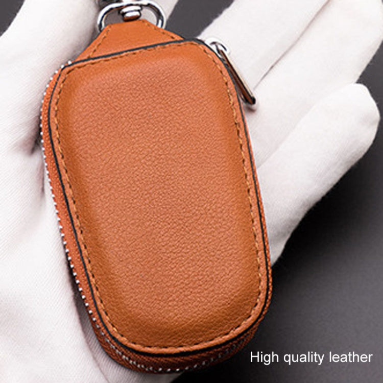 Orange leather key pouch with stitched edges, zipper top, and key ring