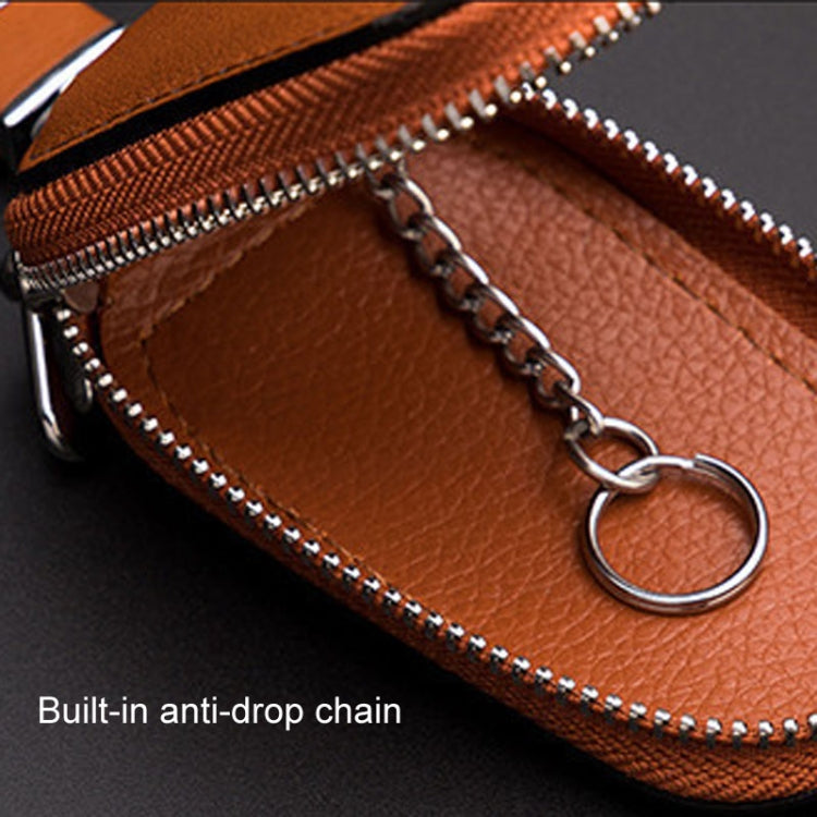 Orange leather key pouch interior with chain attachment and zipper opening