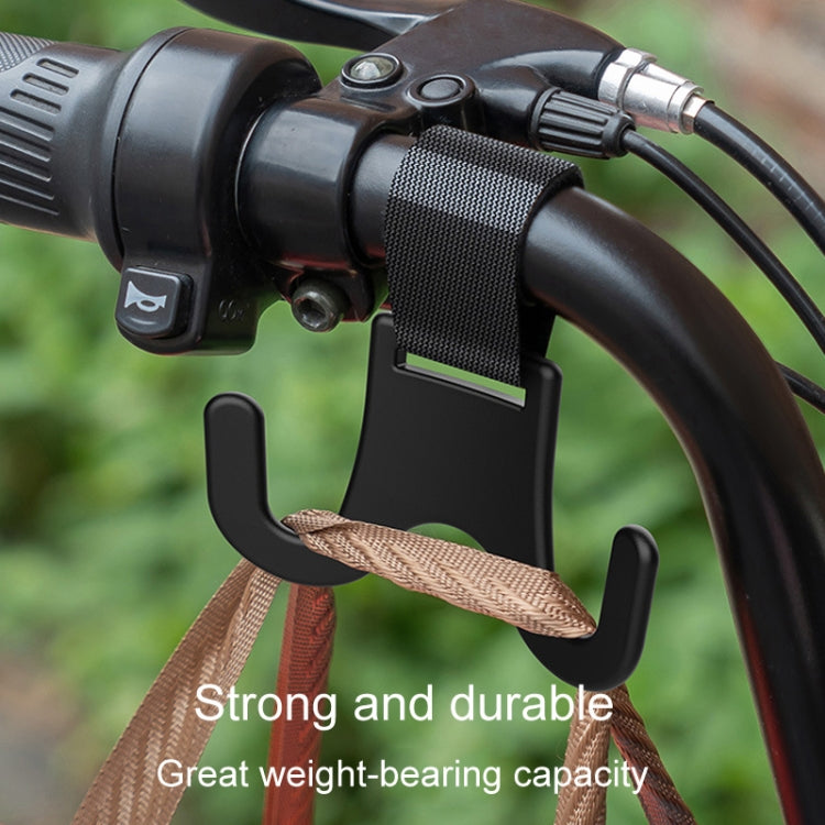 Black pole hanger mounted on a handlebar with textured webbing strap