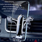 Car air vent phone holder holding a phone, silver-gray metal clamp design