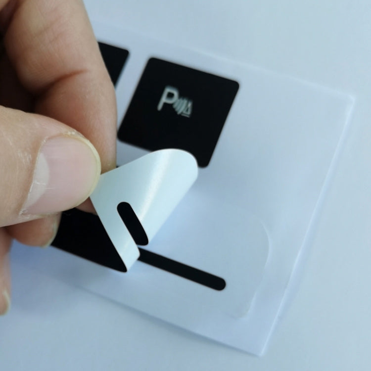 Hand applying black car button sticker with hazard triangle icon on long strip