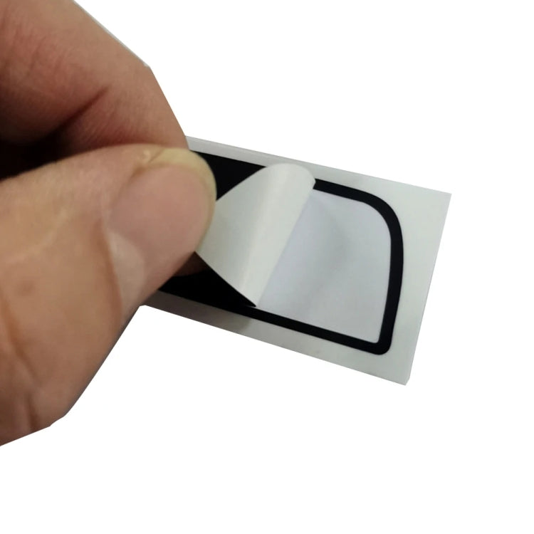 Dashboard repair sticker detail, black backing with clear window and white connector tabs