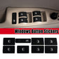 Window switch button repair stickers installed on a car door panel, black with white icons