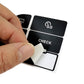 Close-up of hand applying black control button decal sticker with CHECK icon