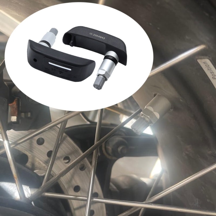 Motorcycle TPMS sensor installed on wheel rim with black valve cap