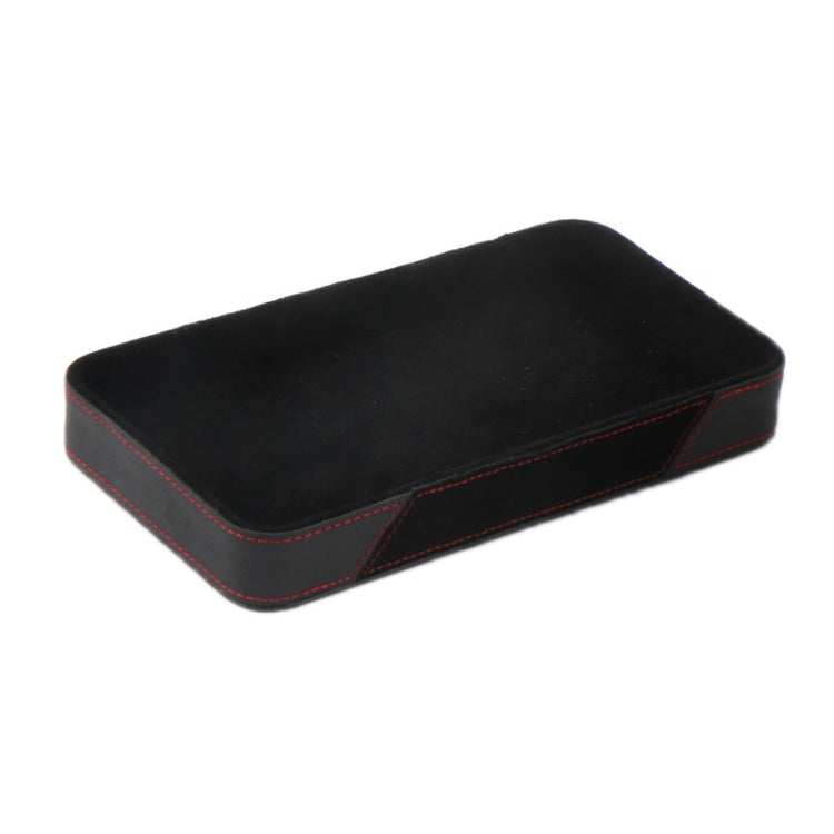 Black car armrest storage box with red stitched edges and smooth top